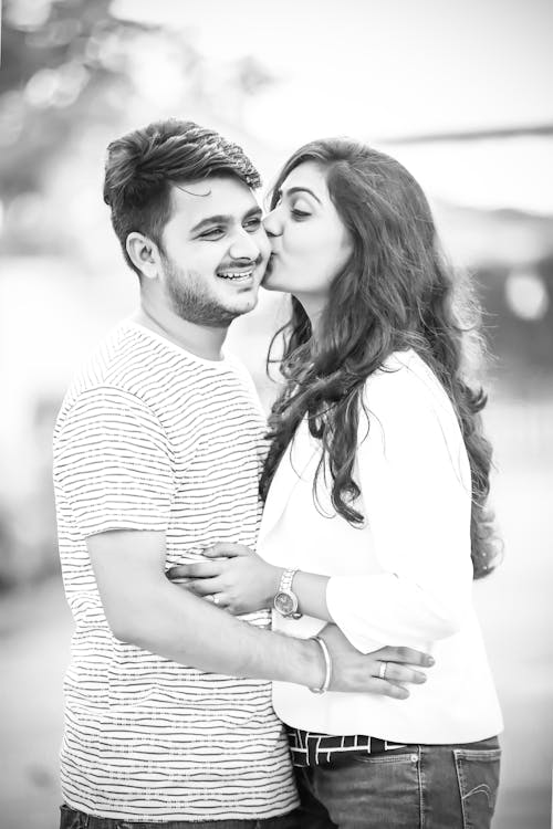 Woman Kissing Man In Striped Shirt