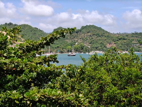 Free Scenic view of a tropical bay with lush hills and sailboats in Samaná, Dominican Republic. Stock Photo
