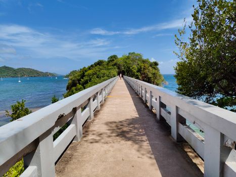 A tranquil bridge path stretching over vibrant waters in Samaná, Dominican Republic, perfect for nature walks.