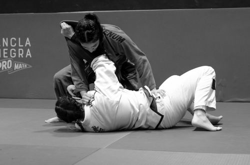 Free Two women engage in Brazilian Jiu Jitsu training, showcasing technique and skill. Stock Photo