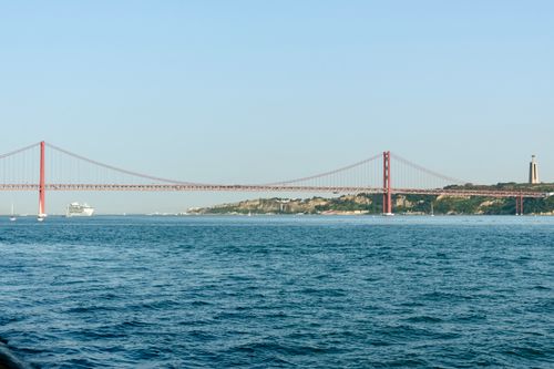 Free A scenic view of the 25 de Abril Bridge spanning over the Tagus River in Lisbon, Portugal. Stock Photo