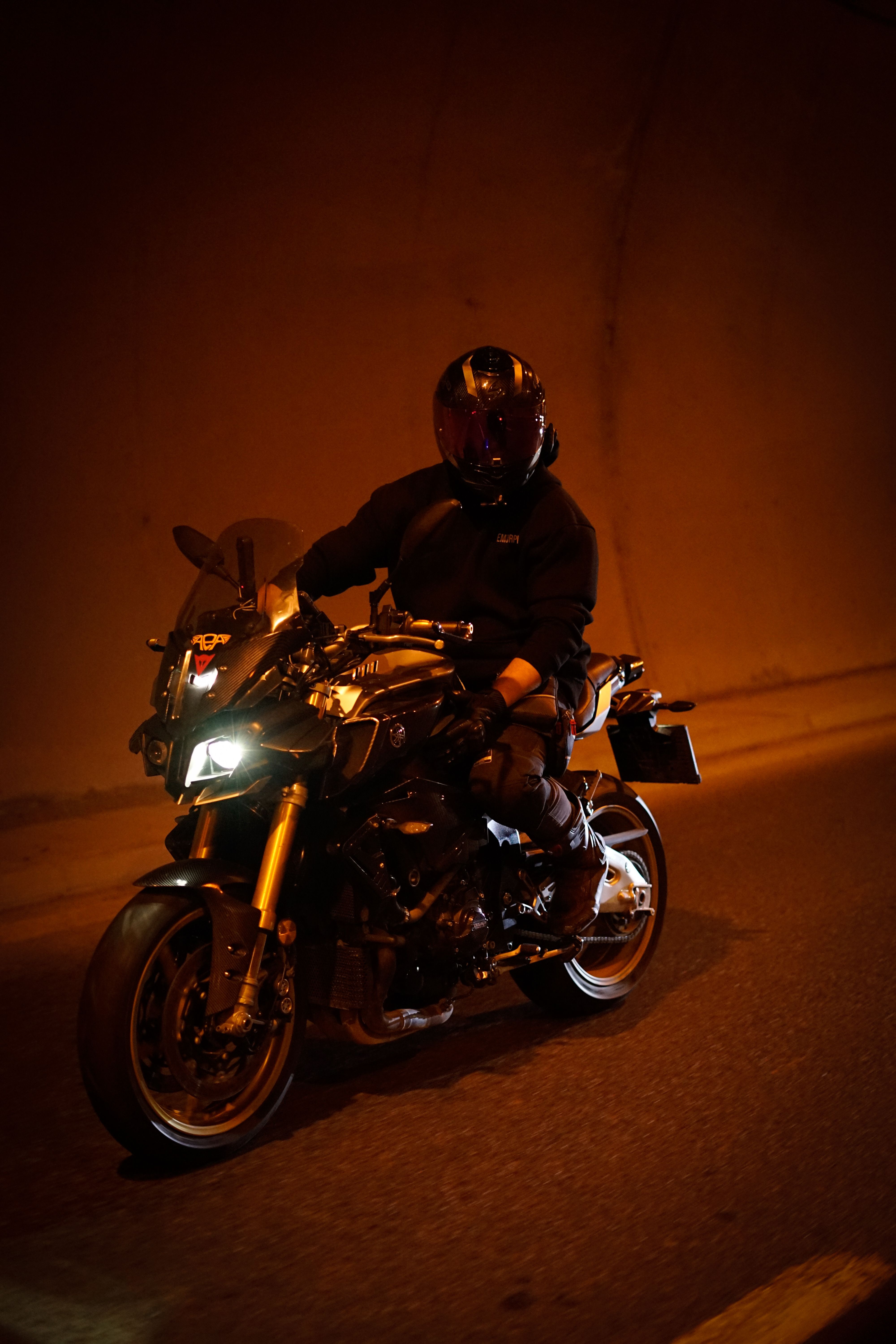 A motorcyclist in a tunnel, showcasing speed and adventure at night.
