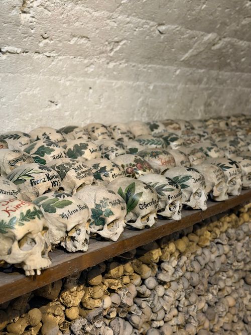 Free A collection of intricately painted skulls displayed in the ossuary of Hallstatt, Austria, showcasing historical tradition. Stock Photo