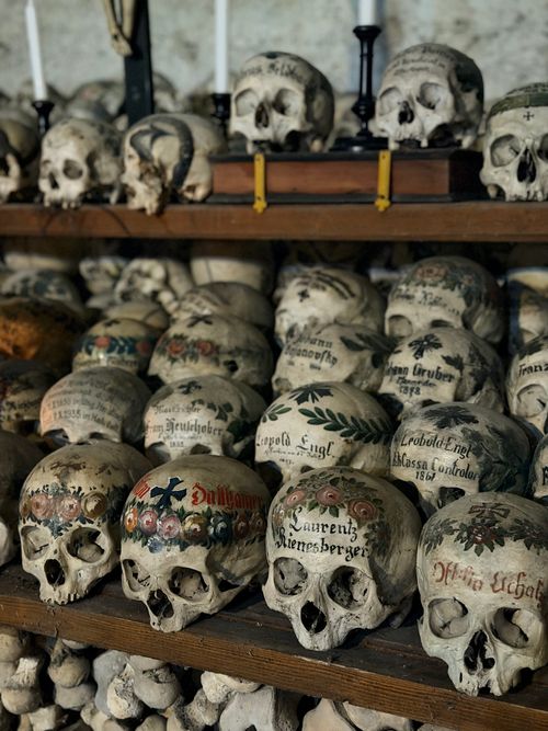 Free Decorative skulls in Hallstatt's ossuary showcasing unique bone house tradition. Stock Photo