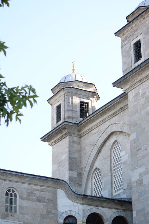 Free Ottoman-style mosque featuring characteristic domes and intricate stonework architecture. Stock Photo