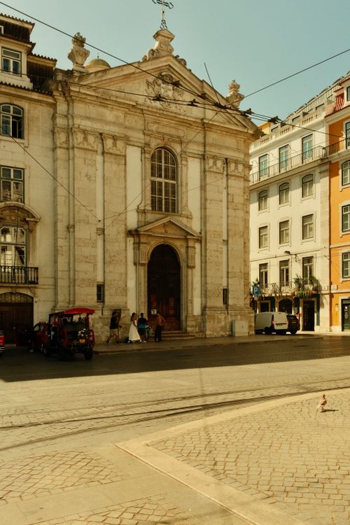 Free Charming street view in Lisbon featuring historic architecture and urban life. Stock Photo