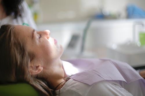 Patient lying on dental chair in clinic