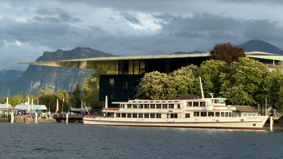 Picturesque Lake Lucerne with a classic paddle steamer and modern architecture.