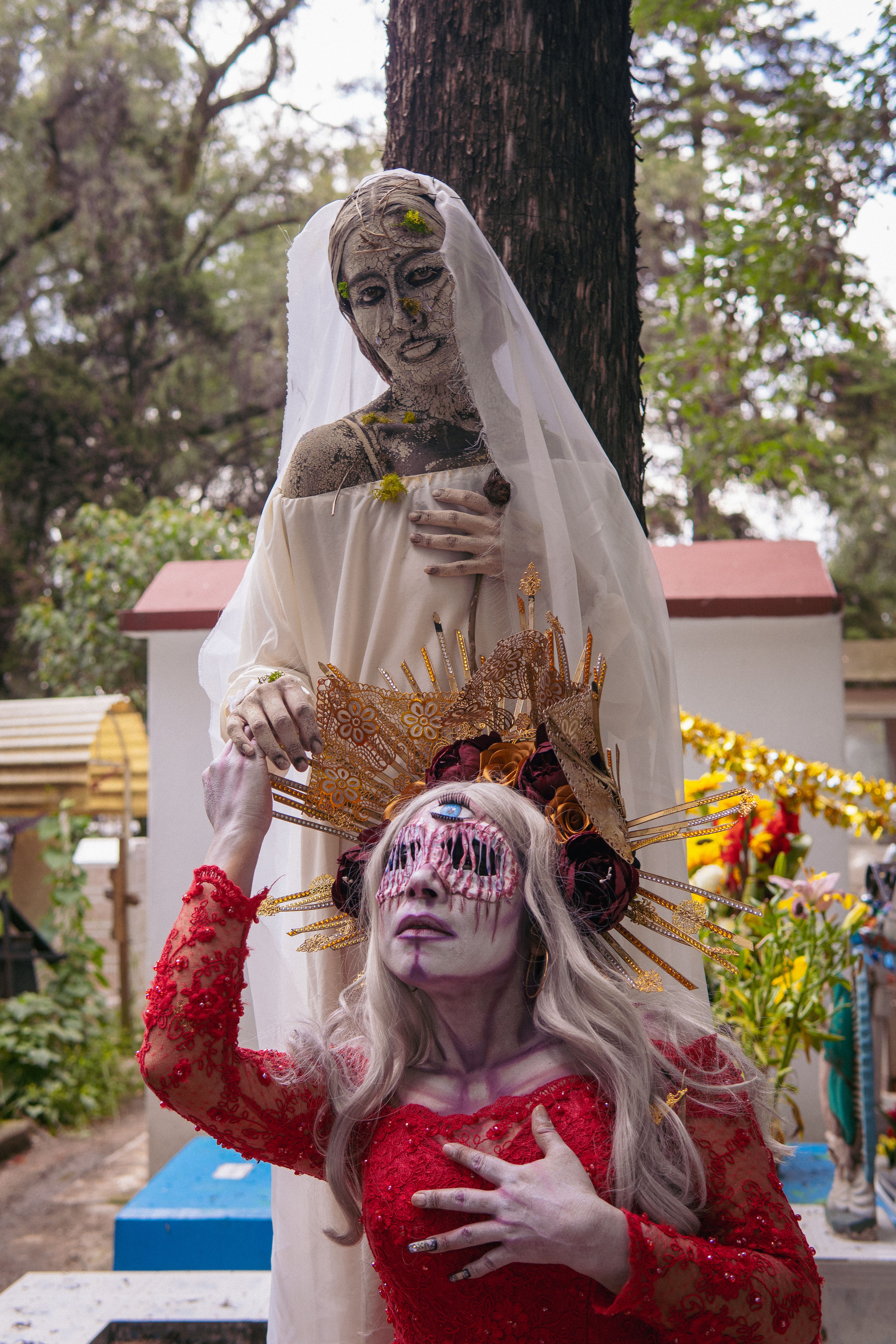 Colorful artistic makeup with a sculpture in Mexico City's historic cemetery.