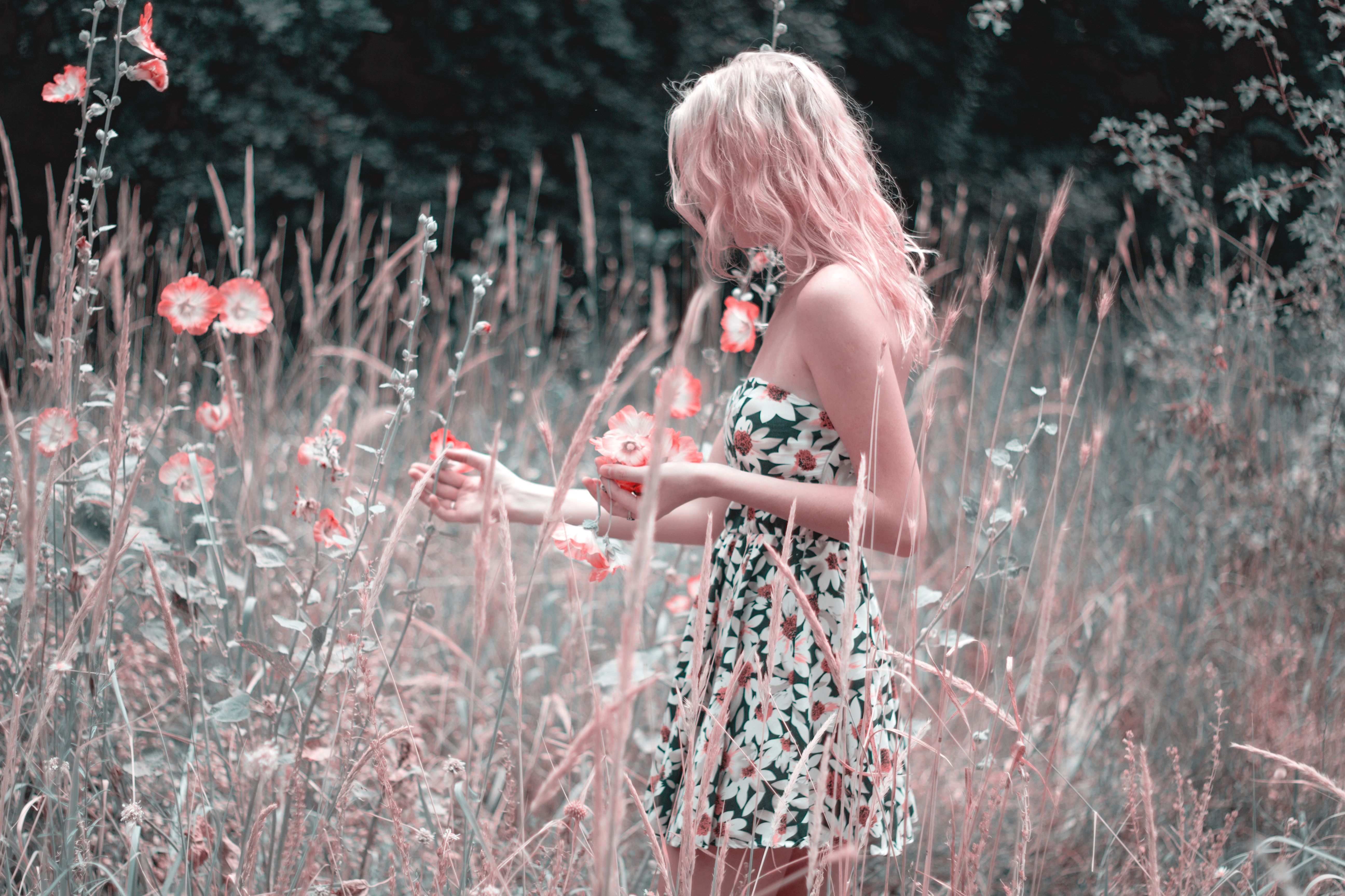 Woman In A Floral Dress Standing On Flower Field · Free Stock Photo