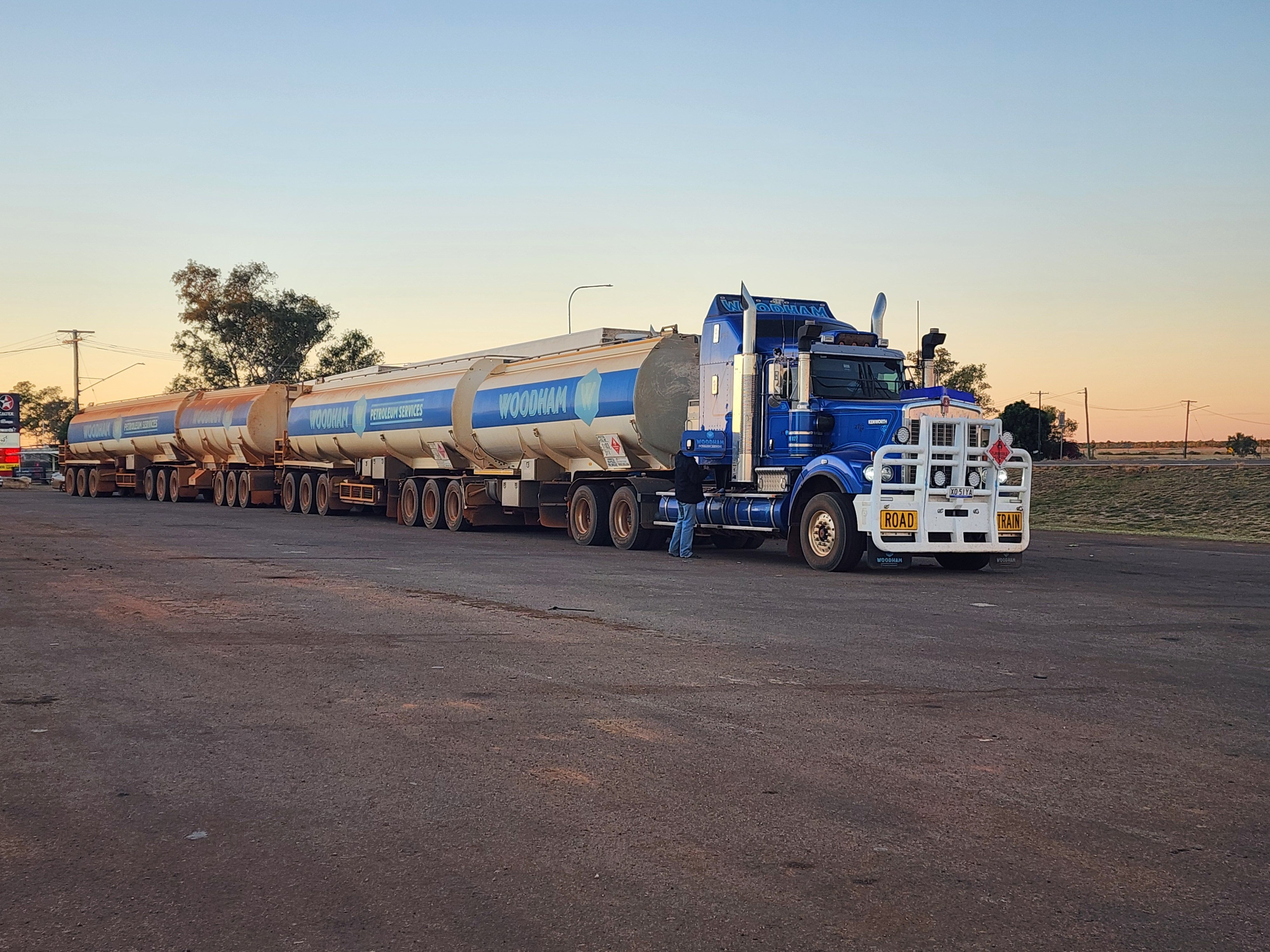 A massive road train parked at sunset in Camooweal, showcasing the rugged beauty of the Australian outback.