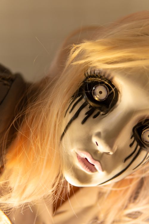 Free Close-up of a spooky doll mask with eerie makeup, perfect for Halloween themes. Stock Photo