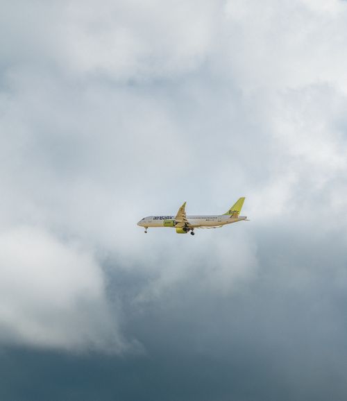 Free A passenger plane in flight against a backdrop of thick clouds, showcasing aerial transportation. Stock Photo