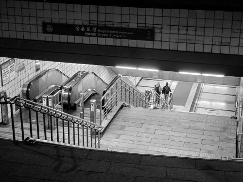 Free Black and white photo of escalators in Mongchontoseong Station, Seoul. Stock Photo