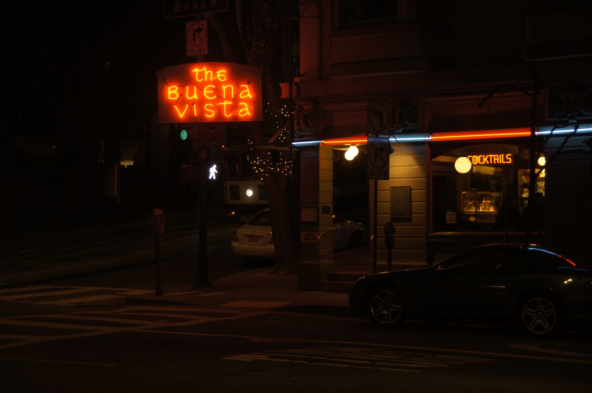 Neon lights illuminate The Buena Vista cocktail bar in San Francisco at night.