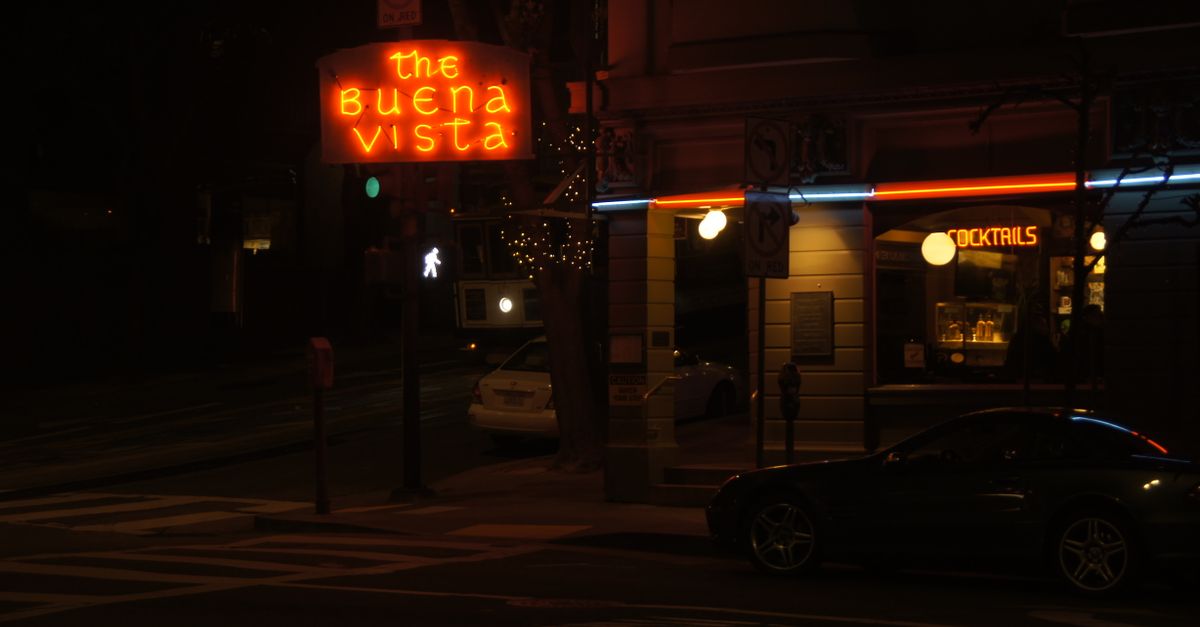 Neon lights illuminate The Buena Vista cocktail bar in San Francisco at night.