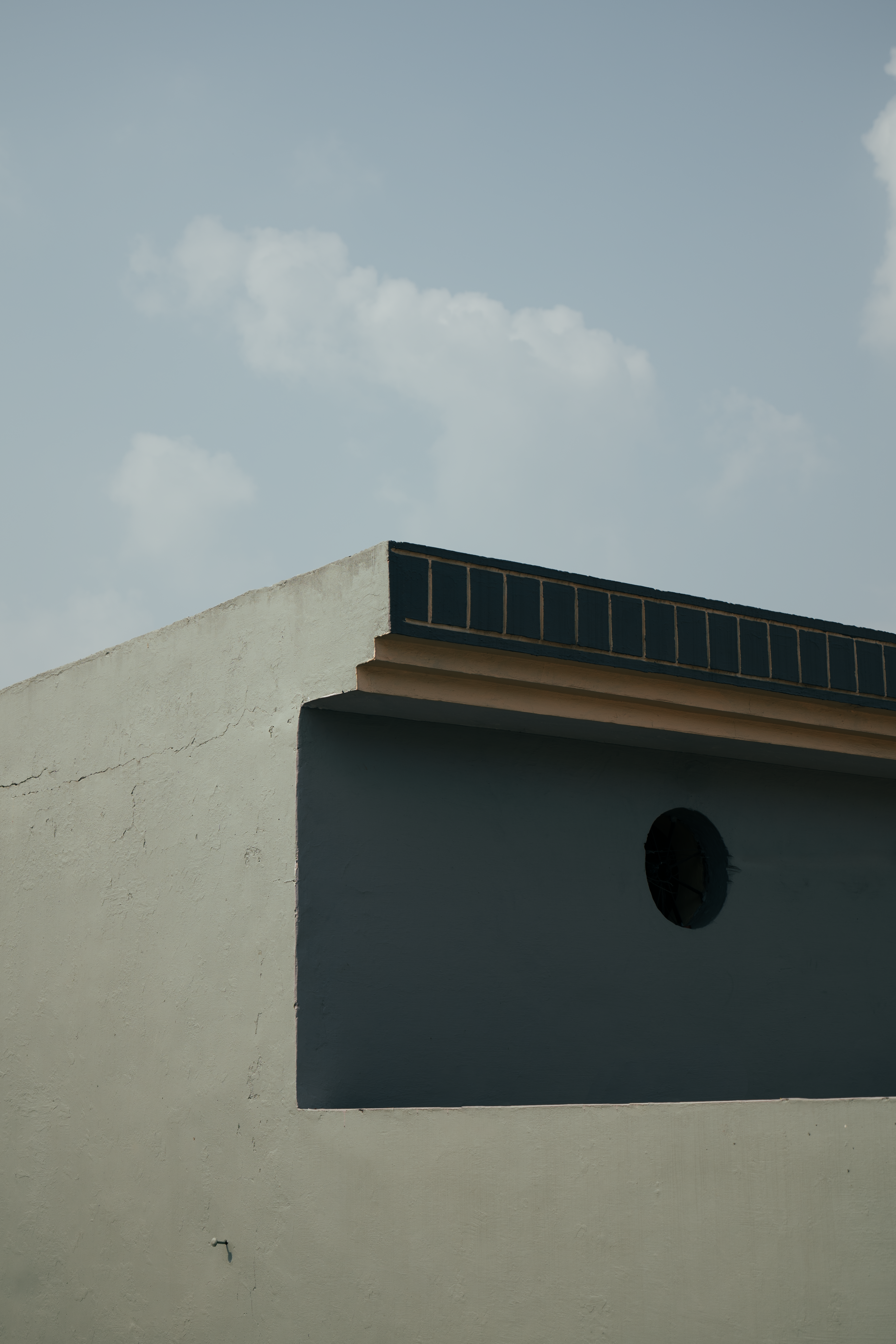 Simple rooftop architecture with geometric lines and clear sky. Minimalist style.