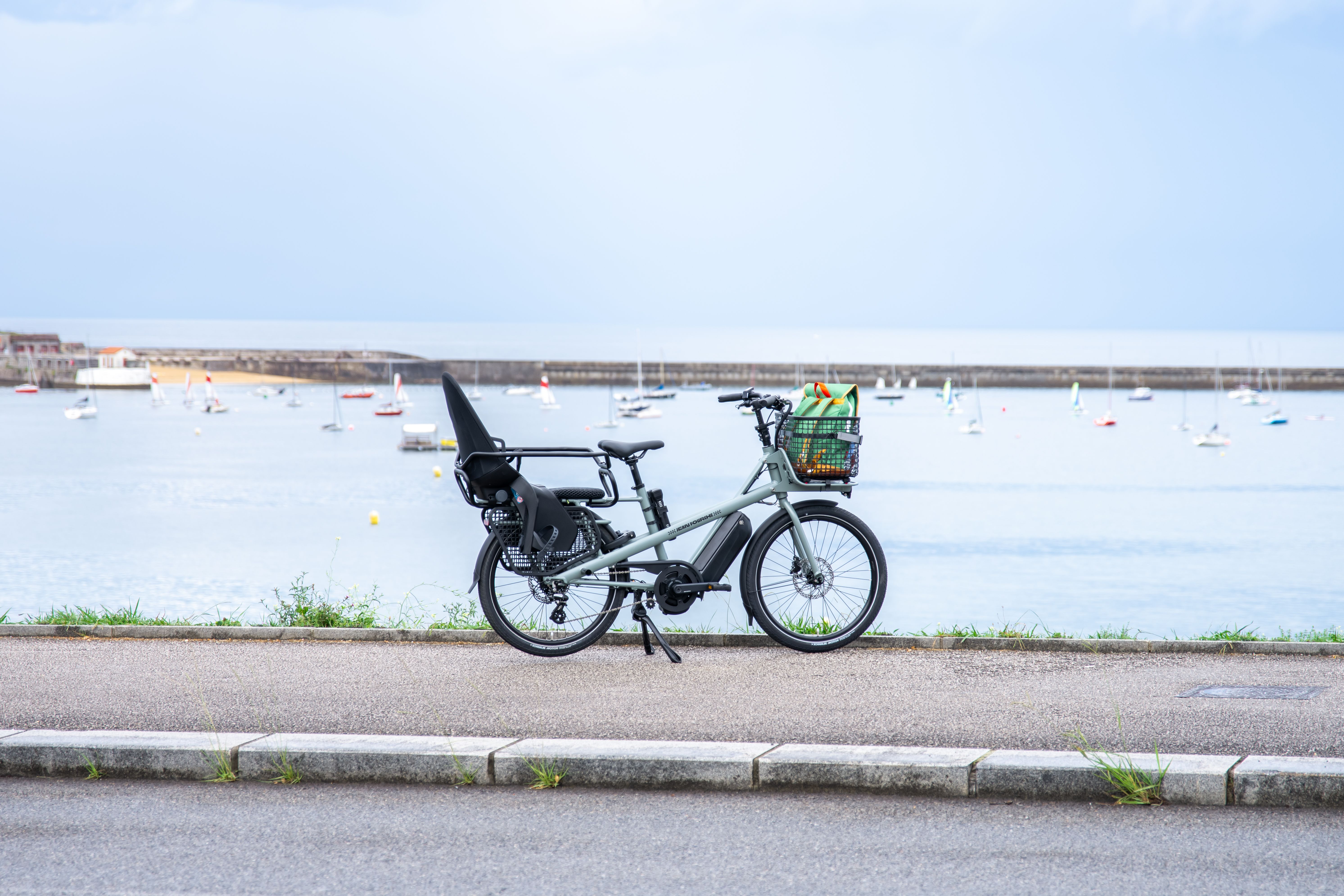 Electric cargo bike on a coastal path in France.