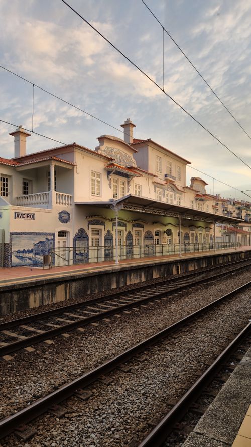 Free The picturesque and historic Aveiro train station captured in warm, soft light during dusk. Stock Photo