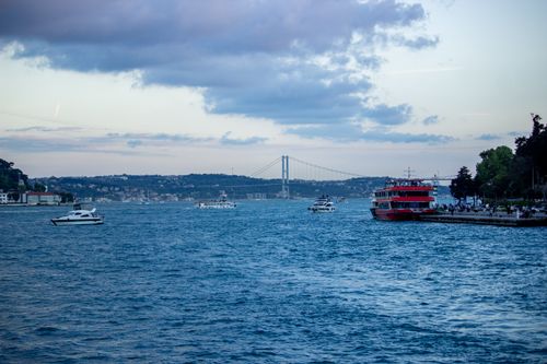 Free A beautiful view of the Bosphorus Strait in Istanbul with boats and a bridge under a cloudy sky. Stock Photo