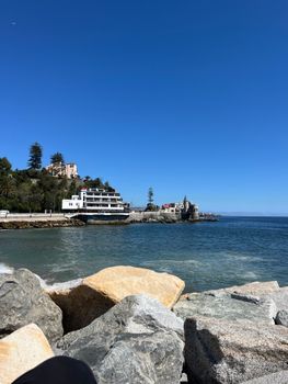Stunning view of Viña del Mar's coastline with clear blue skies and rocky shore.