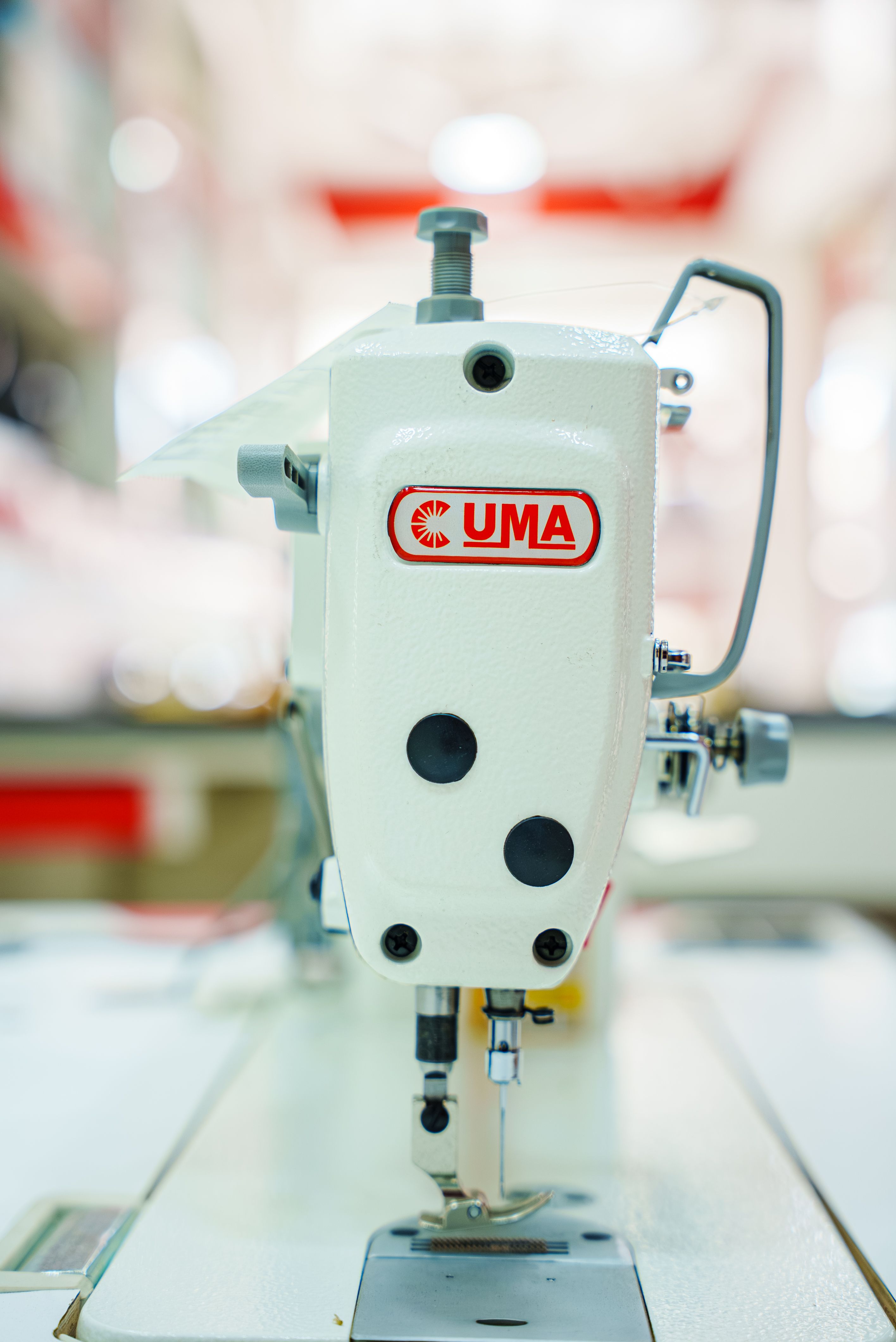 Detailed image of an industrial sewing machine highlighting precision craftsmanship in tailoring.