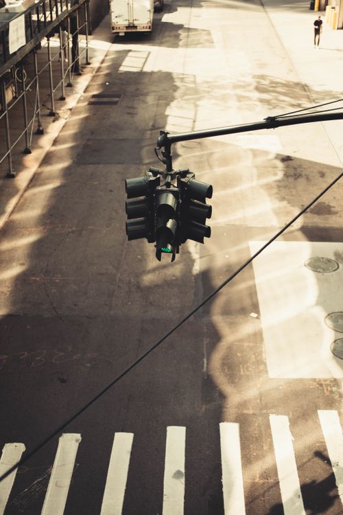 Free A high-angle view of an urban traffic light above a crosswalk in New York City. Stock Photo