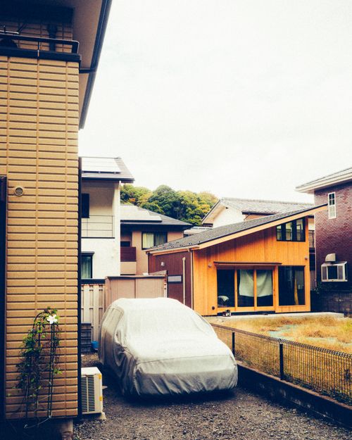 Free Residential neighborhood in Tokyo featuring parked car and modern houses. Peaceful suburban lifestyle captured. Stock Photo