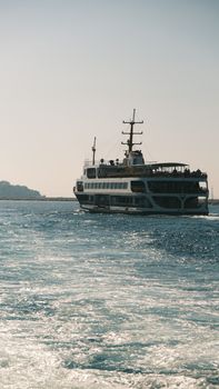A ferry sails through calm ocean waters on a clear, sunny day offering a peaceful maritime experience.