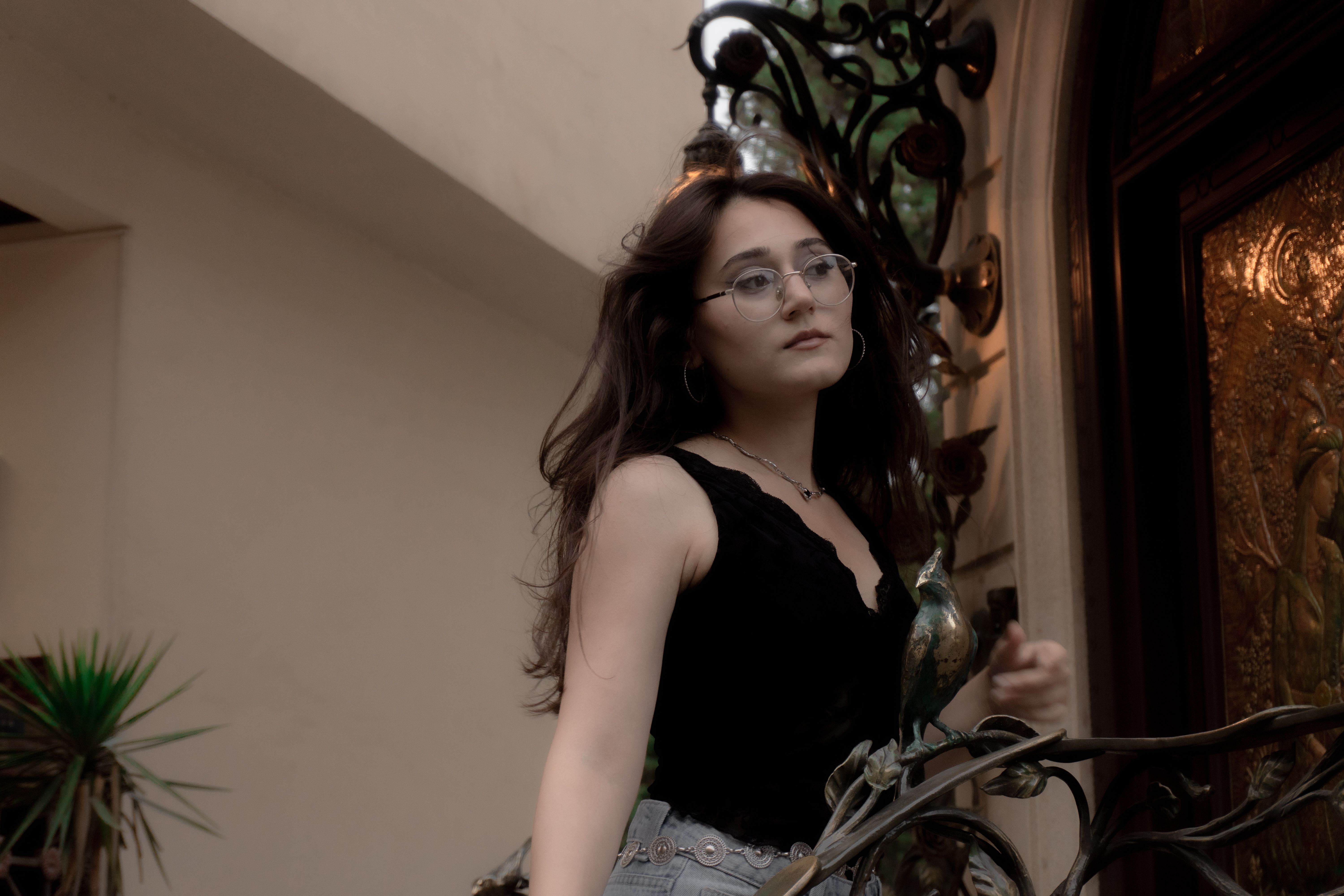 Elegant woman with glasses posing indoors in Baku.