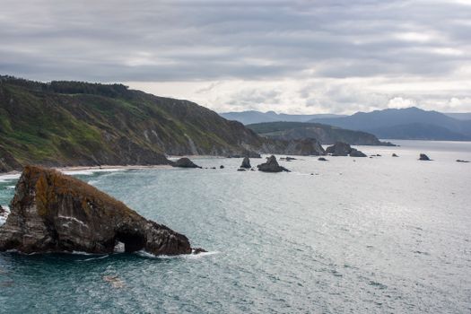 Stunning view of rocky coastal cliffs under a dramatic sky, showcasing nature's beauty.