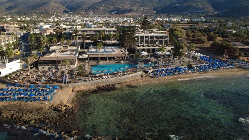 Free Stunning aerial view of a beachfront resort in Malia, Greece, showcasing its pool and sea view. Stock Photo