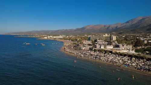 Free Stunning aerial view of Malia Beach, Crete, showcasing the coastline and resort area. Stock Photo
