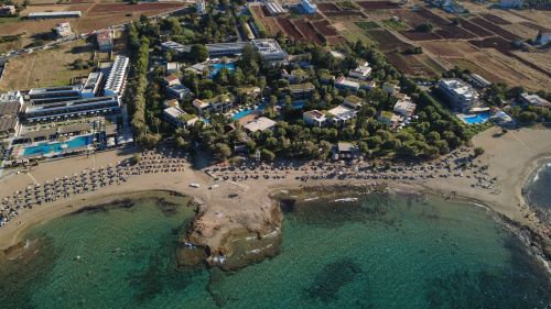Free Aerial capture of Malia's beachfront hotels, Crete, with stunning sea views. Stock Photo