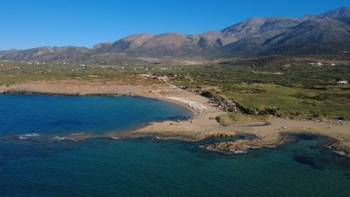 Free Stunning aerial view of Malia beach, Crete showing mountains, sea, and coastline. Stock Photo