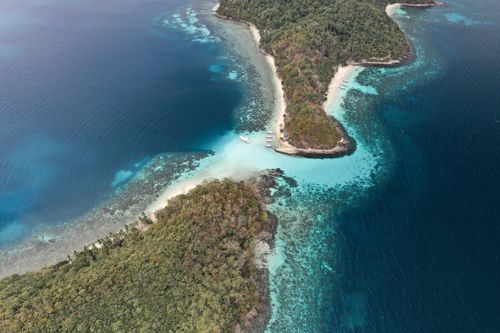 Free Stunning aerial shot of tropical islands in MIMAROPA, Philippines with crystal-clear waters and lush greenery. Stock Photo