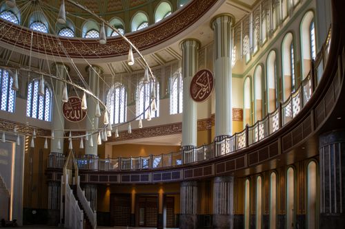 Free A beautifully lit mosque interior in Istanbul showcasing intricate Islamic architecture. Stock Photo