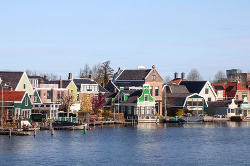 Free Picturesque view of traditional Dutch houses by the canal in Zaandam, Netherlands. Stock Photo