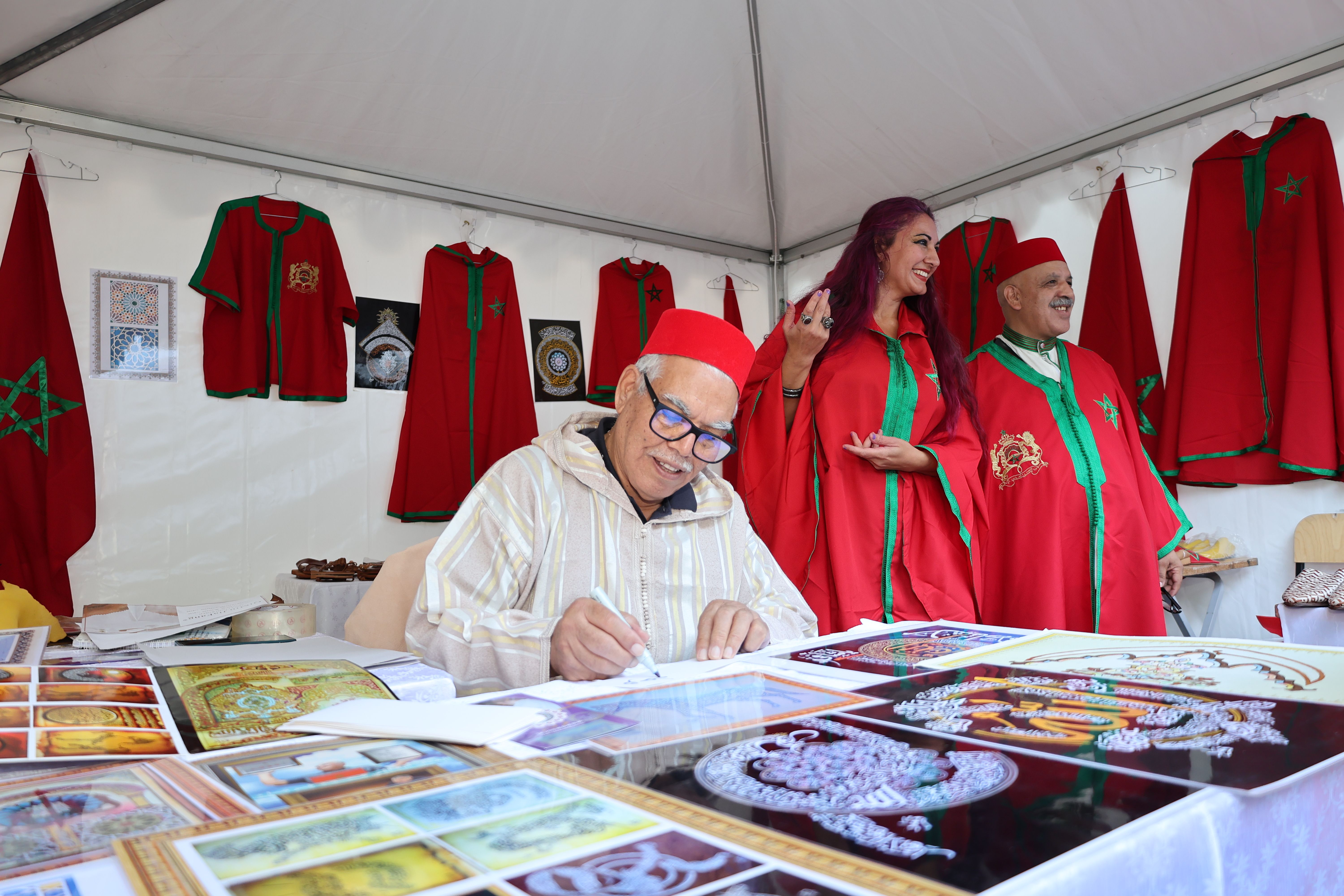 Artisan at Moroccan cultural fair displaying traditional crafts and decoration art.
