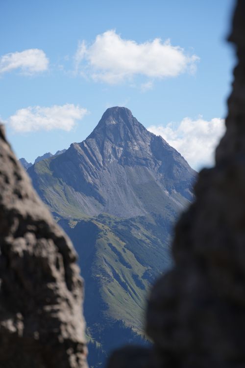 Free Dramatic view of a mountain peak framed by rocks in Schoppernau, Austria. Stock Photo
