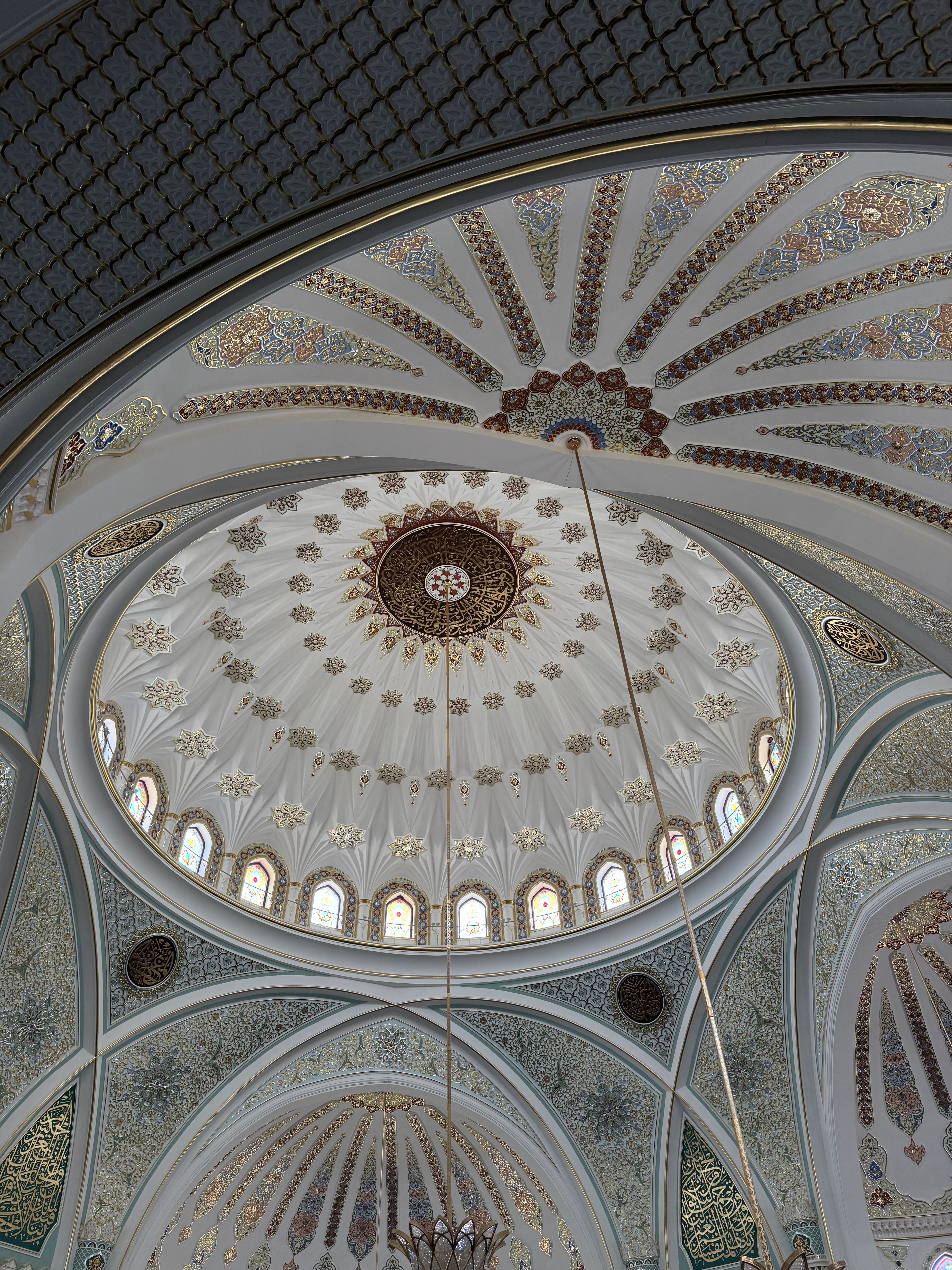 Captivating view of an intricately designed mosque dome, showcasing exquisite geometric and floral patterns.