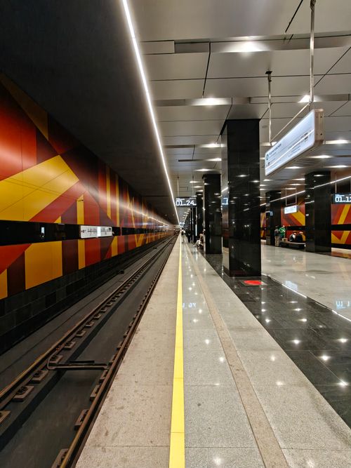 Free A sleek and modern metro station featuring vibrant, geometric wall designs and an empty platform. Stock Photo