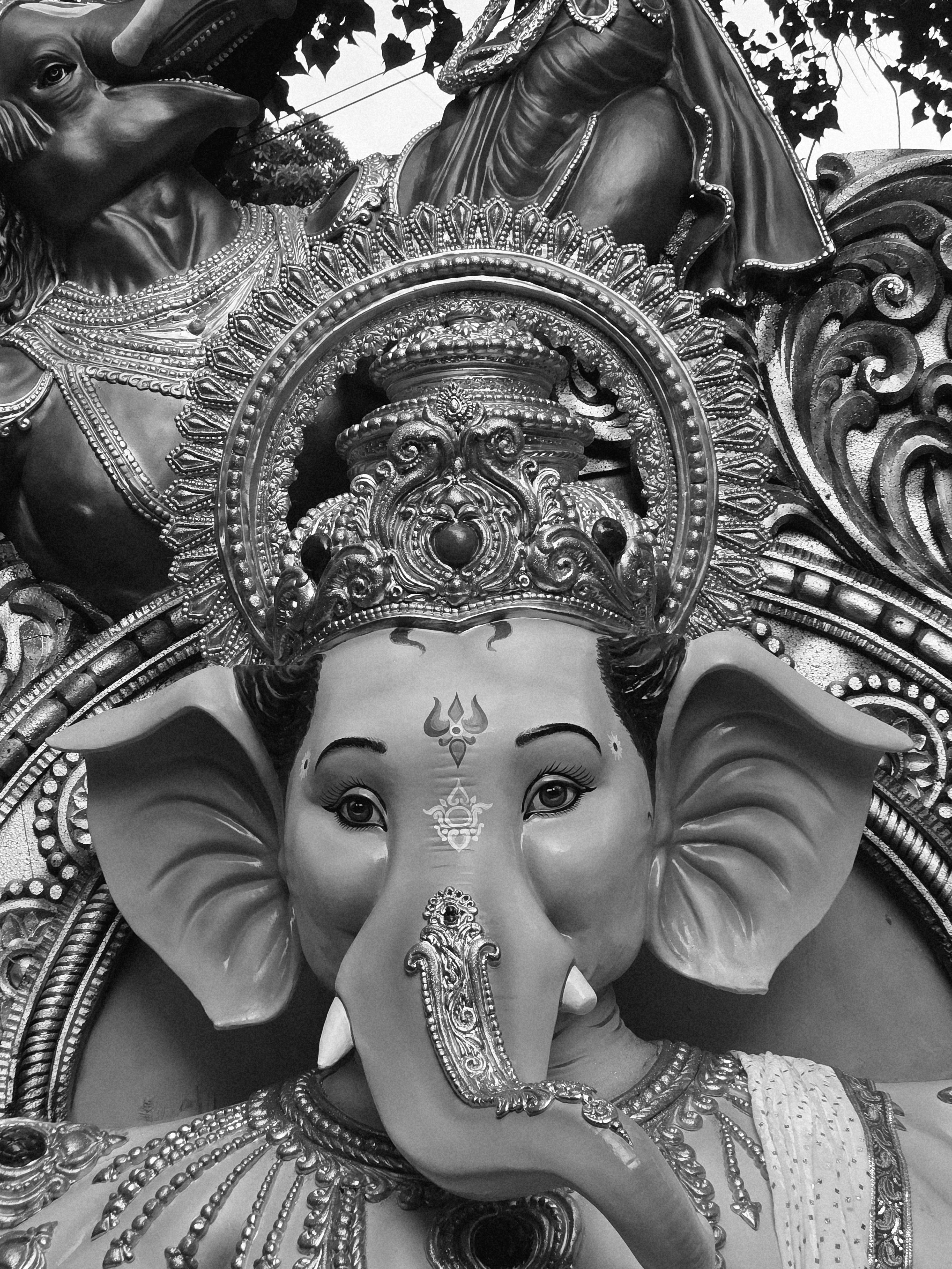 Detailed black and white photo of a Ganesha idol's face with decorative elements in Kolkata, India.