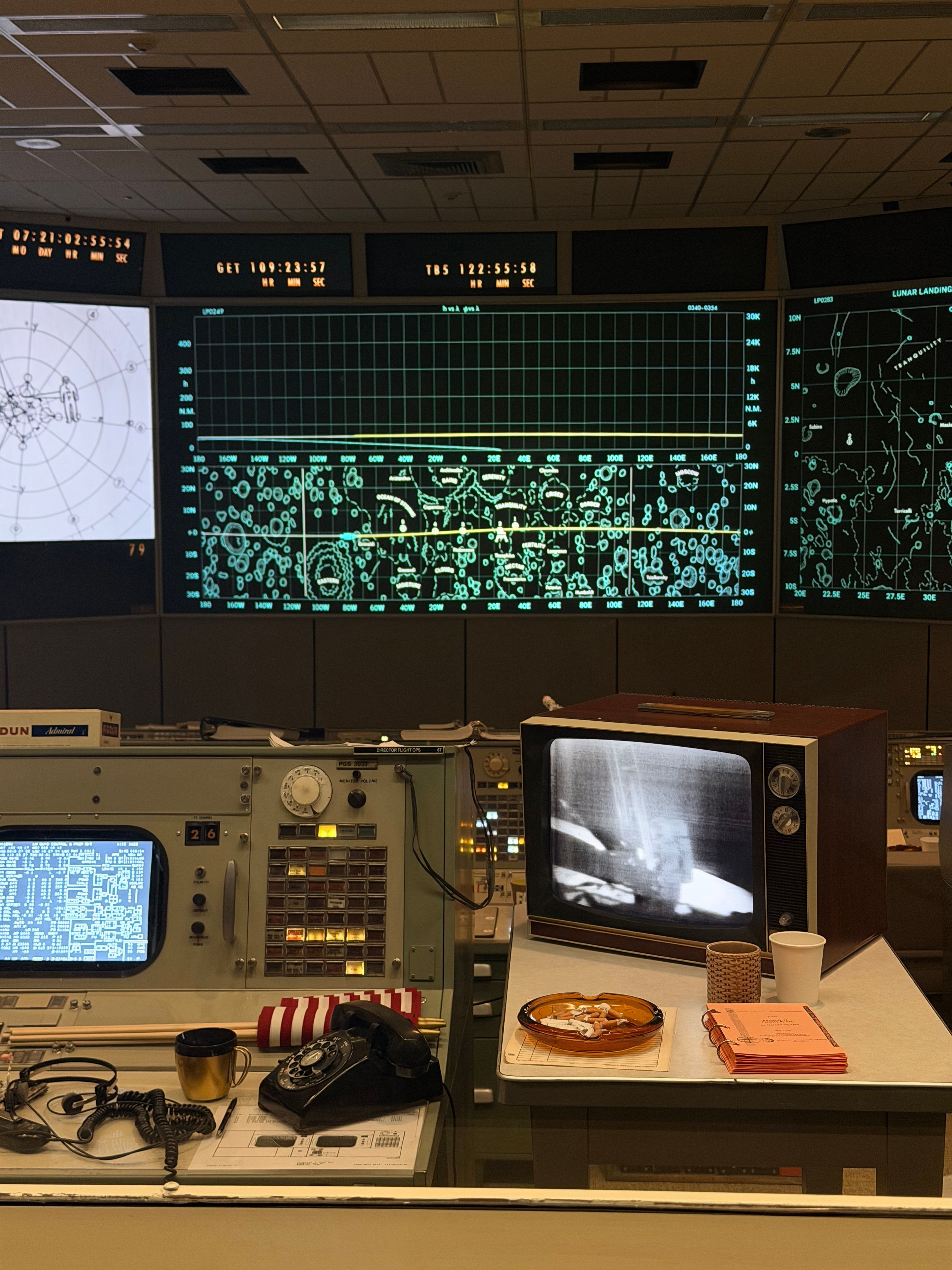 Historic NASA mission control center setup featuring vintage technology and Apollo mission screens.