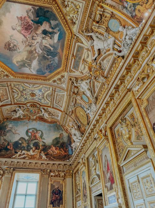 Free Intricate artwork and golden details adorn the ceiling of a luxurious European palace interior. Stock Photo