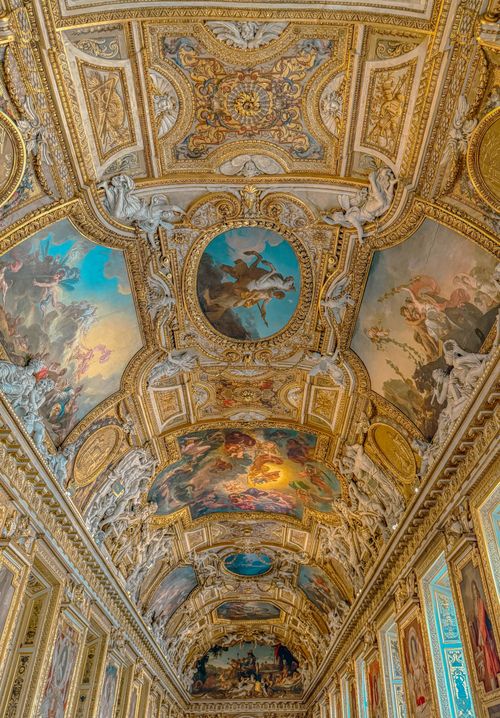Free Intricately painted ceiling in a European palace with classical frescoes and golden details. Stock Photo