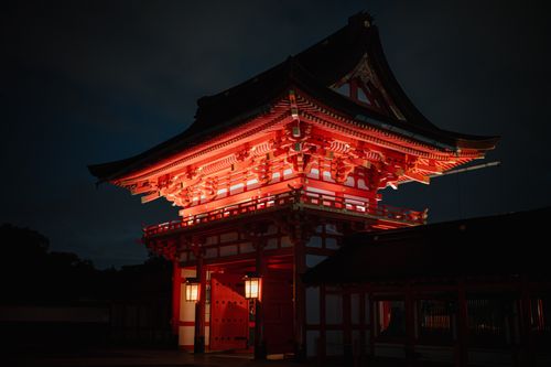 Free Stunning nighttime view of a brightly lit traditional Japanese temple gate in Kyoto. Stock Photo