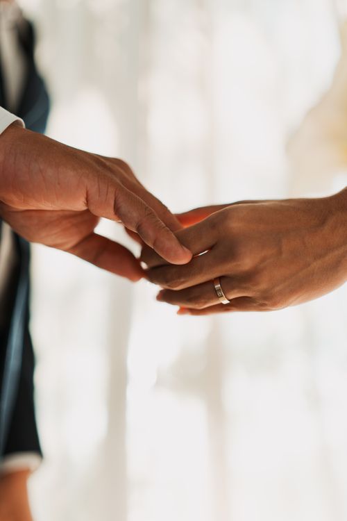 Free Close-up of a couple holding hands during their wedding ceremony, showcasing love and commitment. Stock Photo