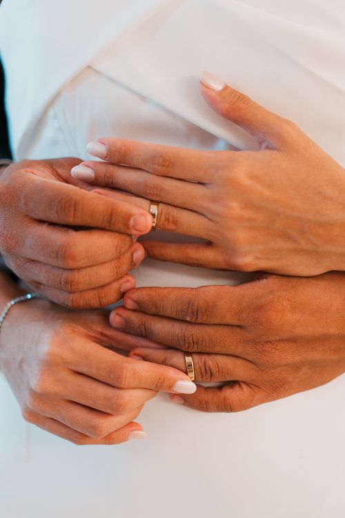 Free A tender close-up of couples' hands showcasing wedding rings, symbolizing love and unity. Stock Photo