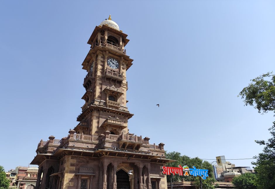 The iconic Ghanta Ghar clock tower in Jodhpur, India, under clear blue skies.